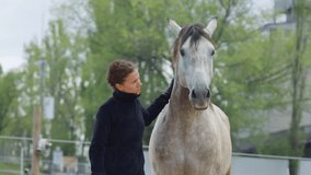 A person bonding affectionately with a horse in a serene farm setting. - Powered by Shutterstock - Get 15% off with code: PIKWIZARD15