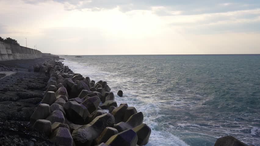 Dramatic Sunrise Timelapse Over the Coastline with Sun Rays, Angel's Ladder, and Shifting Clouds Over the Ocea