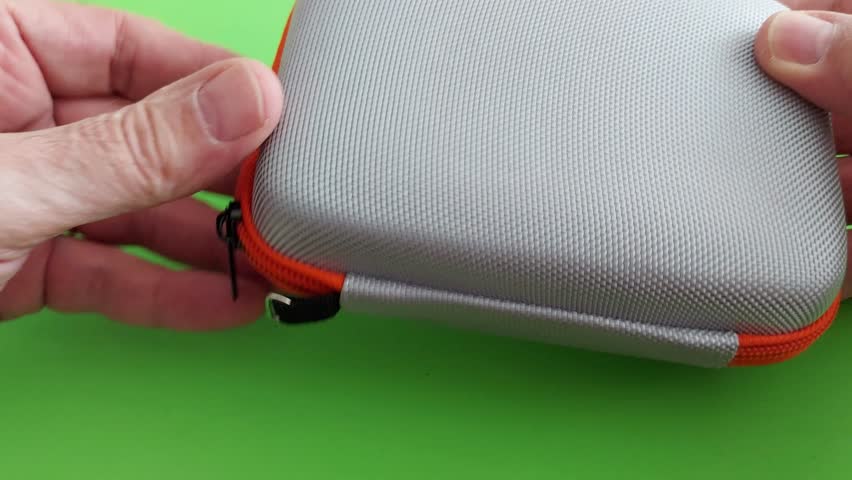 Vibrant orange mini case with mesh pocket-compact, durable, and perfect for organizing travel essentials