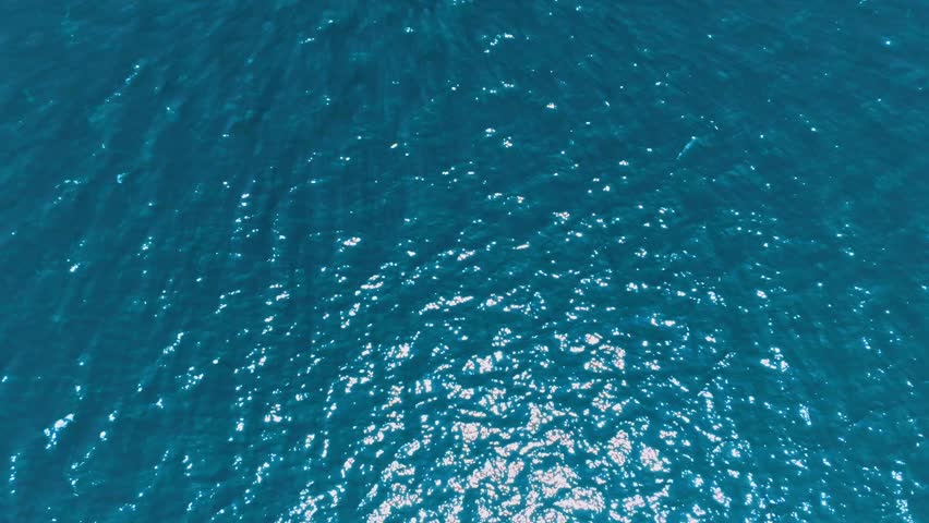 Sunlight Reflections on Deep Blue Water – Natural Light Art on the Surface