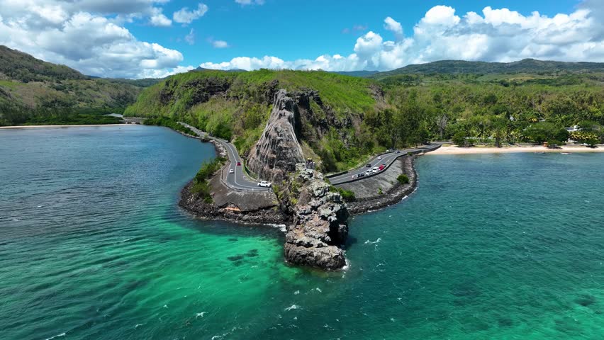 Aerial view of the emerald Indian Ocean meeting cliffs and coastal curves at the famous Maconde Viewpoint, Mauritius