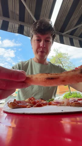 Relishing the experience of enjoying a wonderful and delicious pizza while outdoors in the fresh air