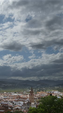 Clouds moving in time lapse in San Juan church, Velez Malaga, Spain. 4K Vertical