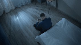 Lonely man sitting on the floor in a dark room in a state of despair and depression. The concept of stress, problems and mental health. - Powered by Shutterstock - Get 15% off with code: PIKWIZARD15