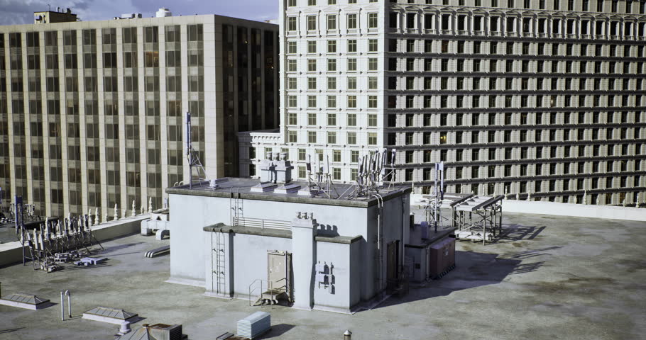 High above a bustling city, rooftops are filled with communication antennas and equipment. The buildings create a striking skyline under a partly cloudy sky, showcasing urban architecture.