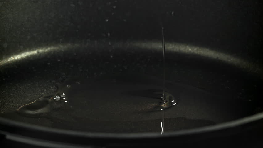 The oil is poured into a frying pan. Filmed on a high-speed camera at 1000 fps. High quality FullHD footage