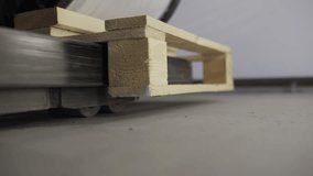 Wooden pallet unloading from forklift mover inside a production or warehouse setting - Powered by Shutterstock - Get 15% off with code: PIKWIZARD15