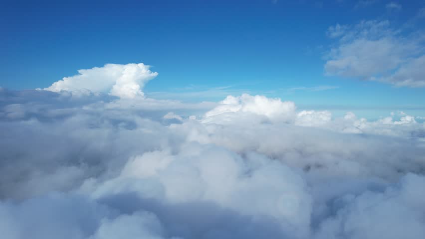 Breathtaking aerial footage flying above soft, fluffy clouds with clear blue sky. Perfect for travel, dreams, nature, or inspirational content. Peaceful and cinematic view from the sky.
