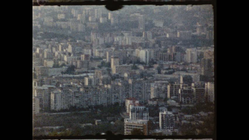 Grenoble cityscape panning showing urban sprawl and mountains