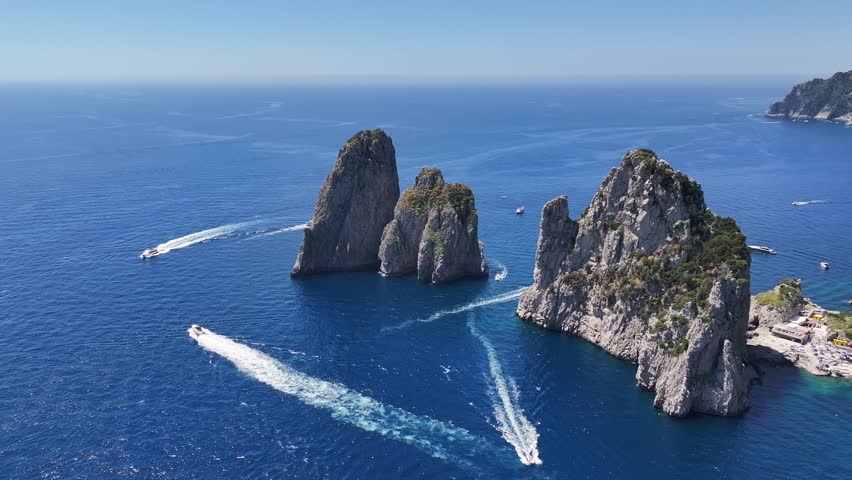Faraglioni Rocks At Capri In Naples Italy. Beach Landscape. Tourism Landmark. Faraglioni Rocks At Capri In Naples Italy. Bay Of Naples Skyline. Geological Formation. Paradisiac Capri Island.