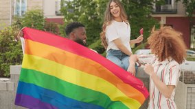 Friends taking a selfie with rainbow flag celebrating pride month - Powered by Shutterstock - Get 15% off with code: PIKWIZARD15