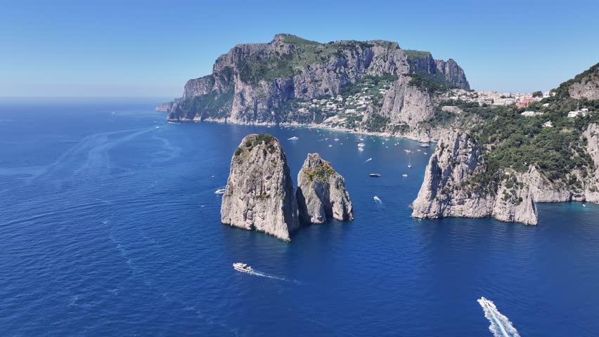 Faraglioni Island At Capri In Naples Italy. Beach Landscape. Giant Cliffs Scene. Faraglioni Island At Capri In Naples Italy. Gulf Of Naples Skyline. Mediterranean Sea Coast. Scenic Capri Island.