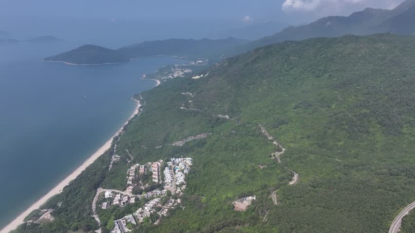 Discover Cheung Sha Beach on Lantau Island, Hong Kong, featuring a stretch of pristine white sand, clear waters, lush greenery, and a peaceful escape from city life perfect for relaxation and beach