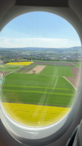 Airplane window view. The airplane is landing on Zurich airport in Switzerland. 
