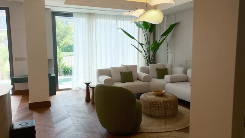 Living room in an expensive private villa in Dubai, illuminated by the sun from panoramic windows