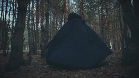 Gothic unrecognizable person evil paranormal character running in night dark dusk forest. Angel of death monster nightmare scares is chasing victim. Fantasy evil person. black hood cape back rear view - Powered by Shutterstock - Get 15% off with code: PIKWIZARD15