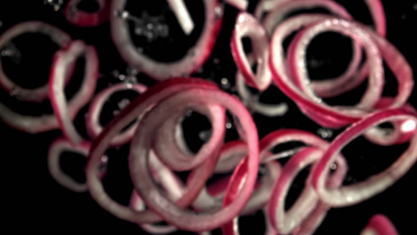 Sliced red onion rings fly up and fall down. Filmed on a high-speed camera at 1000 fps. High quality FullHD footage