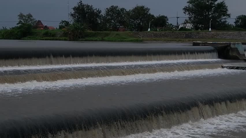 Water flows over a Rubber Dam in Indonesia