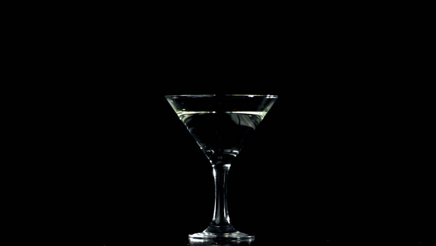 The olives fall into a martini glass. Filmed on a high-speed camera at 1000 fps. High quality FullHD footage