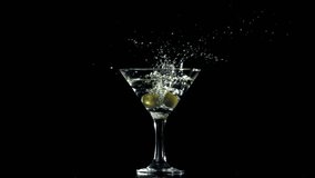 The olives fall into a martini glass. Filmed on a high-speed camera at 1000 fps. High quality FullHD footage - Powered by Shutterstock - Get 15% off with code: PIKWIZARD15