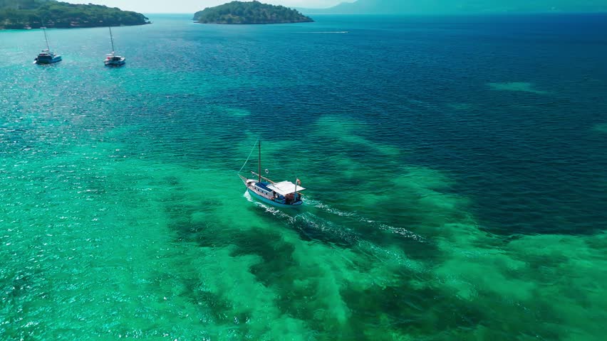 Aerial view of Playa de Formentor at Cala Pi de la Posada bay in Mallorca. Stunning beach with sailing boats floating on turquoise waters at Cap Formentor, Majorca, Balearic Islands, Spain.