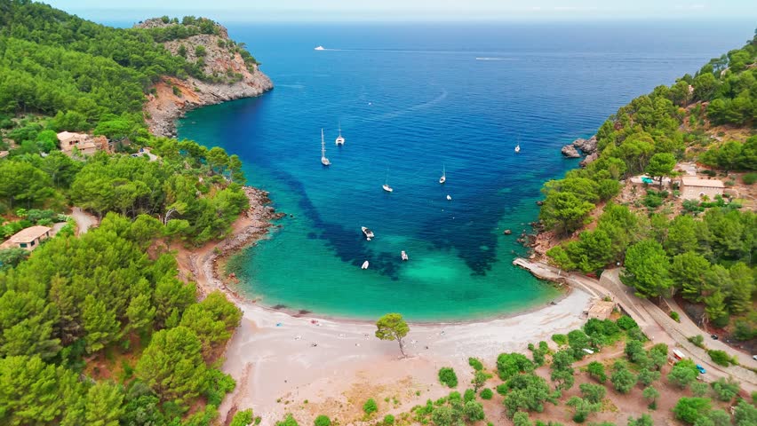 Aerial view of Tuent beach in Mallorca, Balearic Islands, Spain. Scenic idyllic beach with crystal-clear turquoise waters, a popular summer getaway on Majorca island.