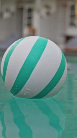 A Colorful Beach Ball is Playfully Floating on Water, Capturing All the Summer Vibes