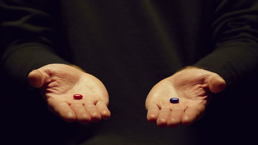 Hands offering a choice between red and blue pills.