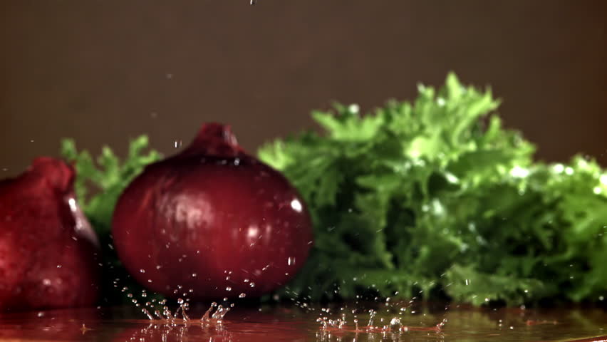 The onion falls on a wet cutting board. Filmed on a high-speed camera at 1000 fps. High quality FullHD footage