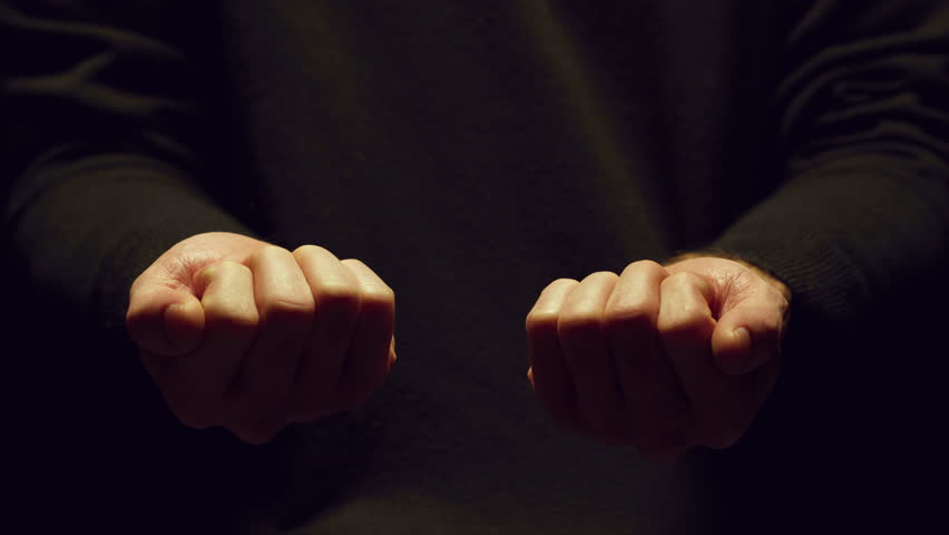 Two hands holding a red and a blue pill.