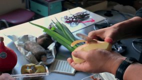 Hands peeling potato with small knife in kitchen, vegetable preparation for cooking, fresh produce on counter, home meal prep, traditional food preparation process - Powered by Shutterstock - Get 15% off with code: PIKWIZARD15