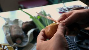 Hands peeling potato with small knife in kitchen, vegetable preparation for cooking, fresh produce on counter, home meal prep, traditional food preparation process - Powered by Shutterstock - Get 15% off with code: PIKWIZARD15