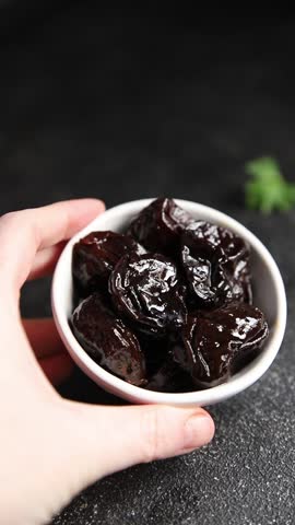 Prunes dried plum smoked drained gourmet food background on the table rustic food top view copy space keto and paleo diet vegetarian and vegan food