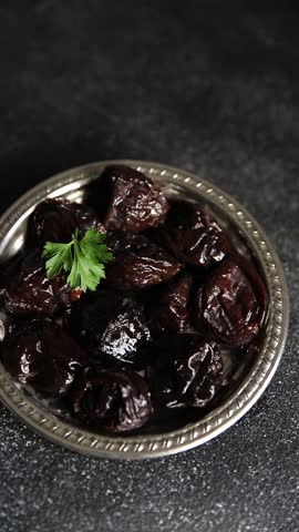Prunes dried plum smoked drained gourmet food background on the table rustic food top view copy space keto and paleo diet vegetarian and vegan food