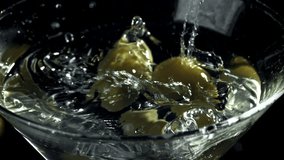 The olives fall into a martini glass. Filmed on a high-speed camera at 1000 fps. High quality FullHD footage - Powered by Shutterstock - Get 15% off with code: PIKWIZARD15