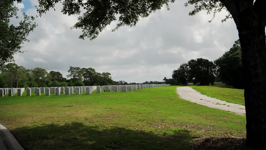 Cemetery of Army veteran with the white headstones. Retired military soldiers tombs. Memorial or Veteran Day concept.