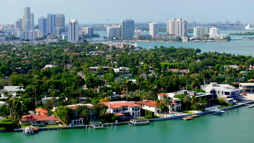 Miami luxury mansions Sunset Islands. Aerial 4k drone video showing waterfront multimillion dollar homes with docks and views of downtown miami in background
