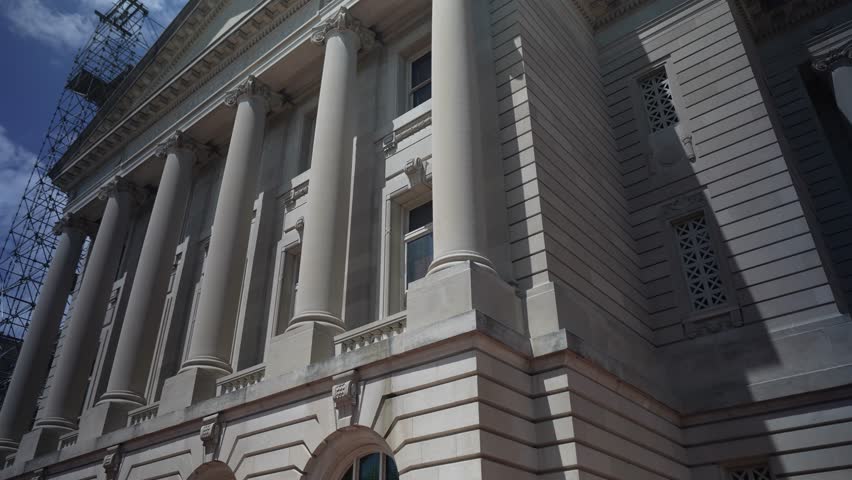 Scaffolding surrounds the Kentucky State Capitol in Frankfort as renovation work advances. The architecture features classic columns and detailed design elements.