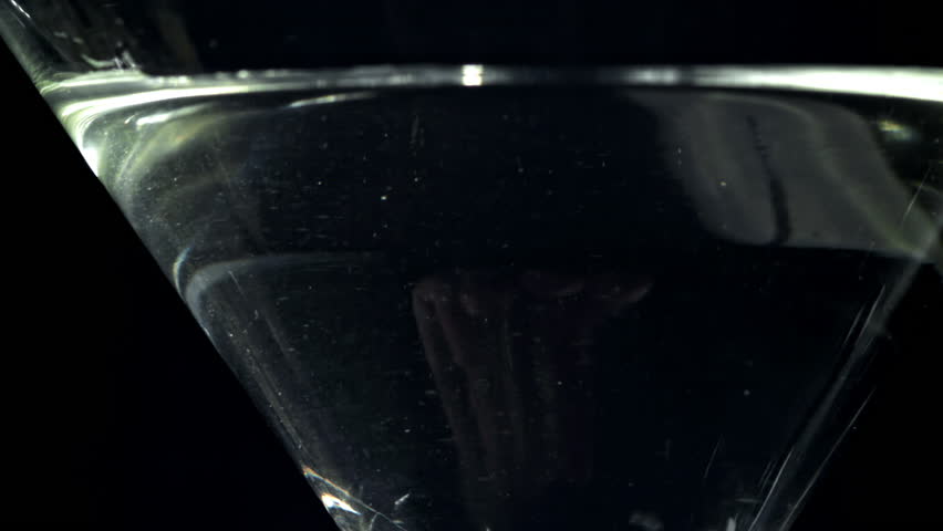 The olives fall into a martini glass. Filmed on a high-speed camera at 1000 fps. High quality FullHD footage