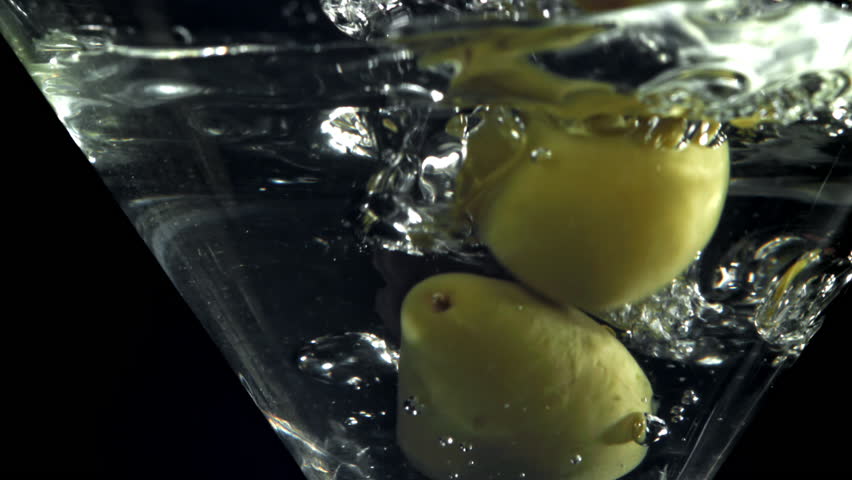 The olives fall into a martini glass. Filmed on a high-speed camera at 1000 fps. High quality FullHD footage
