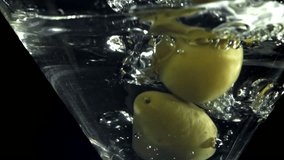 The olives fall into a martini glass. Filmed on a high-speed camera at 1000 fps. High quality FullHD footage - Powered by Shutterstock - Get 15% off with code: PIKWIZARD15