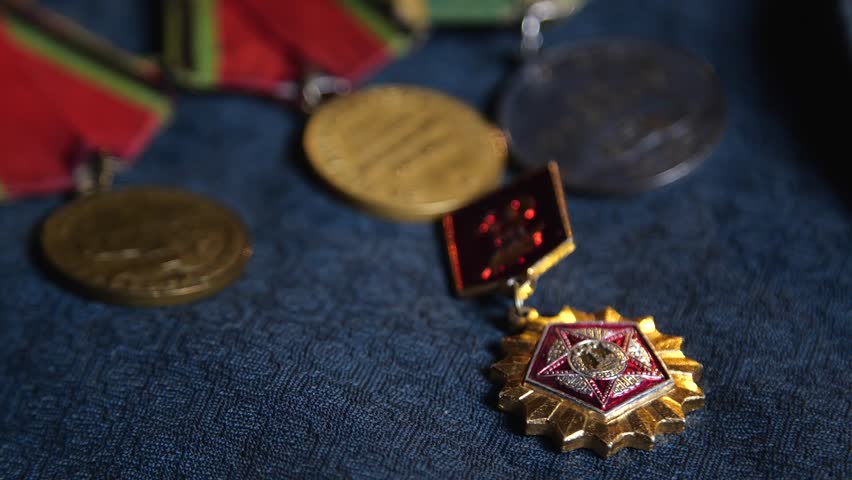 Soviet World War II Medals on Blue Fabric Background