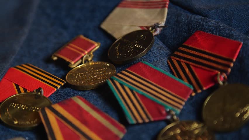 Soviet World War II Medals on Blue Fabric Background