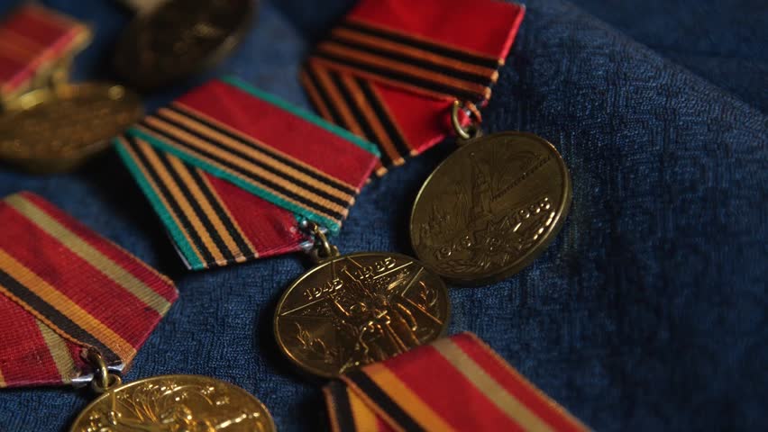 Soviet World War II Medals on Blue Fabric Background