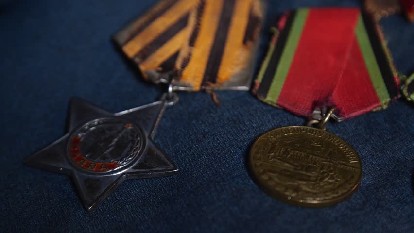 Soviet World War II Medals on Blue Fabric Background