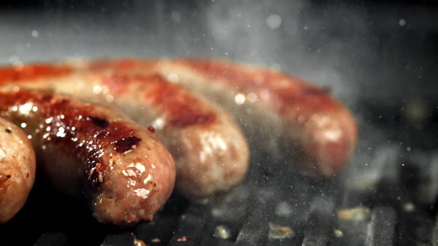 Sausages are fried in a pan with a splash of oil. Filmed on a high-speed camera at 1000 fps. High quality FullHD footage