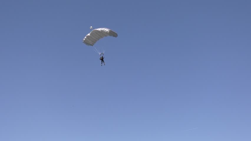 Military paratrooper landing, precision landing, close-up