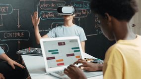 African boy programming system while caucasian girl enter metaverse while sitting at blackboard with engineering code written.high school girl wearing VR or headset in STEM technology. Edification - Powered by Shutterstock - Get 15% off with code: PIKWIZARD15