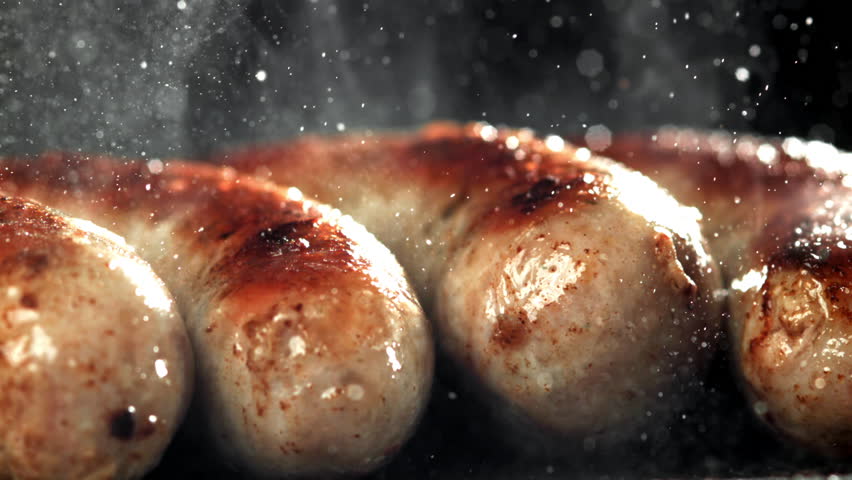 Sausages are fried in a pan with a splash of oil. Filmed on a high-speed camera at 1000 fps. High quality FullHD footage