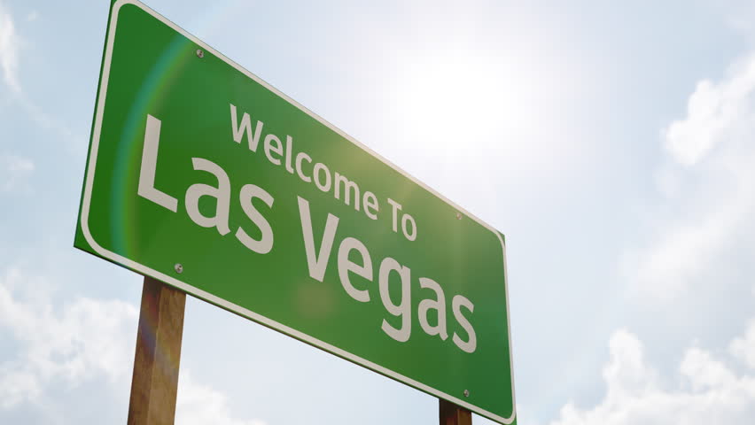 4k Welcome To Las Vegas Green Road Sign and Airplane Flying Low Overhead with Landing Gear Down.